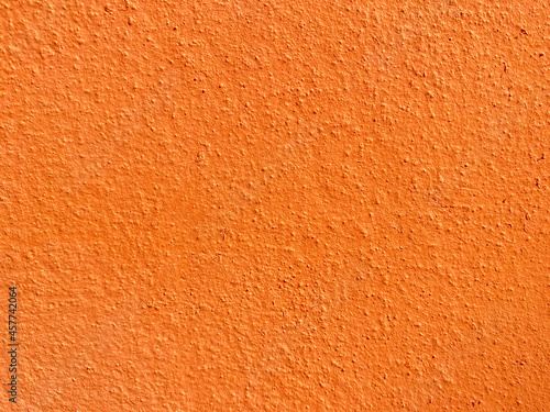 Seamless texture of orange cement wall a rough surface, with space for text, for a background.