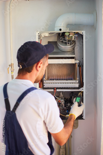 The master engineer maintains the gas heater. Adjusts the combustion of gas in the equipment