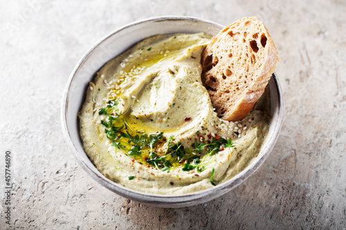 Baba ghanoush, babaganoush or eggplant hummus on the bowl, micro green and spices, traditional Middle Eastern cuisine
