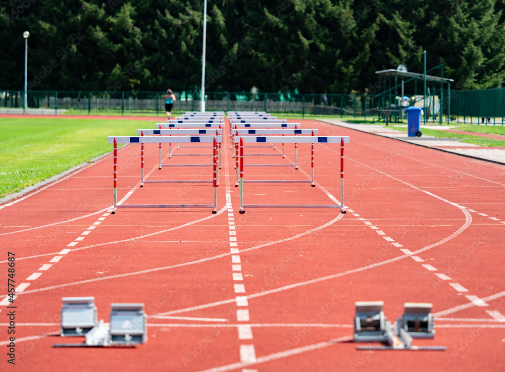 Fototapeta premium Hurdle on the sprint lane with starting blocks