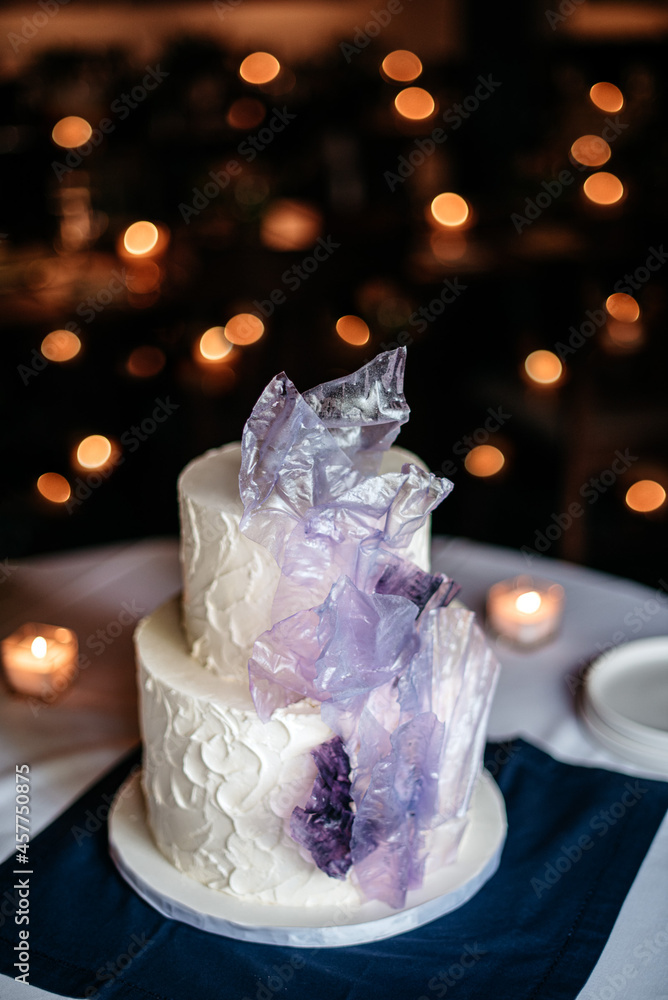 wedding cake with sugar sail decor and twinkle lights at reception wedding cake with sugar sail decor and twinkle lights at reception