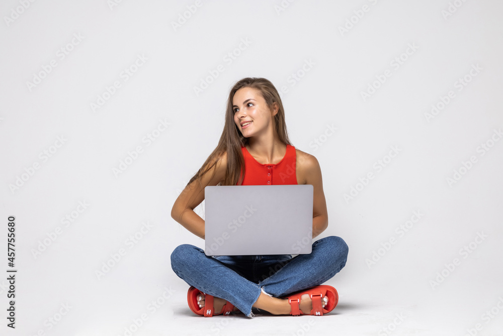 Young Woman with a laptop computer isolated over a white background Young Woman with a laptop computer isolated over a white background