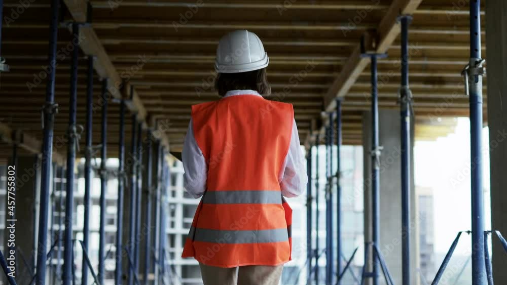Engineer or Architect working at Construction Site. A woman with a tablet at a construction site. Construction concept. Engineer or Architect working at Construction Site. A woman with a tablet at a construction site. Construction concept.
