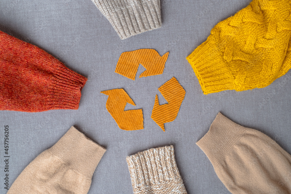 Clothing recycling. Used clothes. Ecological and sustainable fashion.  sleeves of autumn woolen sweaters. reduce waste concept. High quality photo  Stock Photo