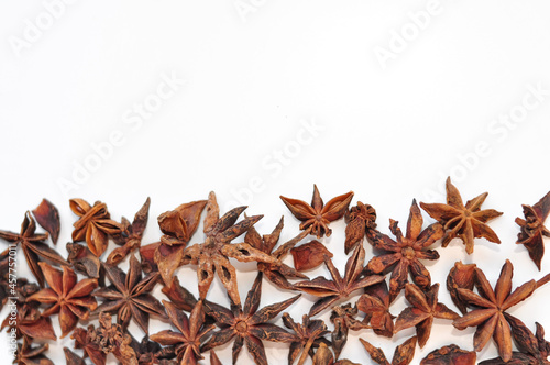 Aromatic anise stars and cinnamon on white background 