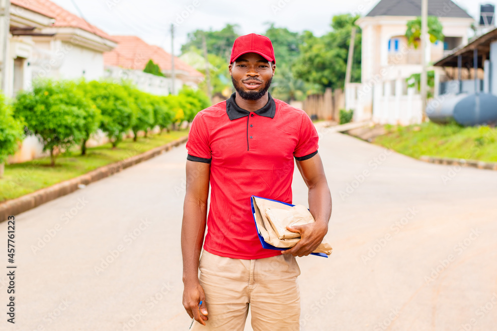 african delivery worker holding some packages african delivery worker holding some packages