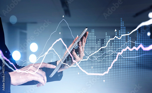 Businesswoman wearing formal suit is holding tablet and touching it