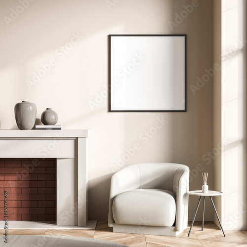 Fireplace and canvas on wall of beige living room with single armchair