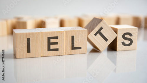 word IELTS on wooden cubes, gray background