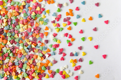 Colorful heart confetti scattered elegantly across a bright canvas, creating a playful and whimsical atmosphere with room for text.