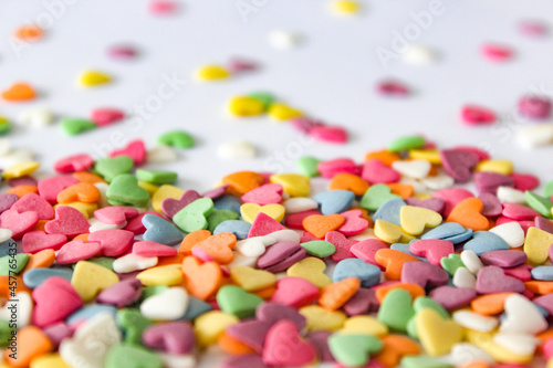 Delightful spread of heart-shaped candies over a clean white surface, capturing the essence of love and celebration.