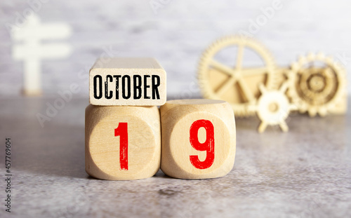 October 19th. Day 19 of month. Calendar cube on modern pink background, concept of bussines and an importent event. photo