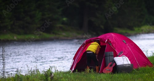 Wallpaper Mural cute kid fiddling around a tent, while having family camping in mountains near the river Torontodigital.ca