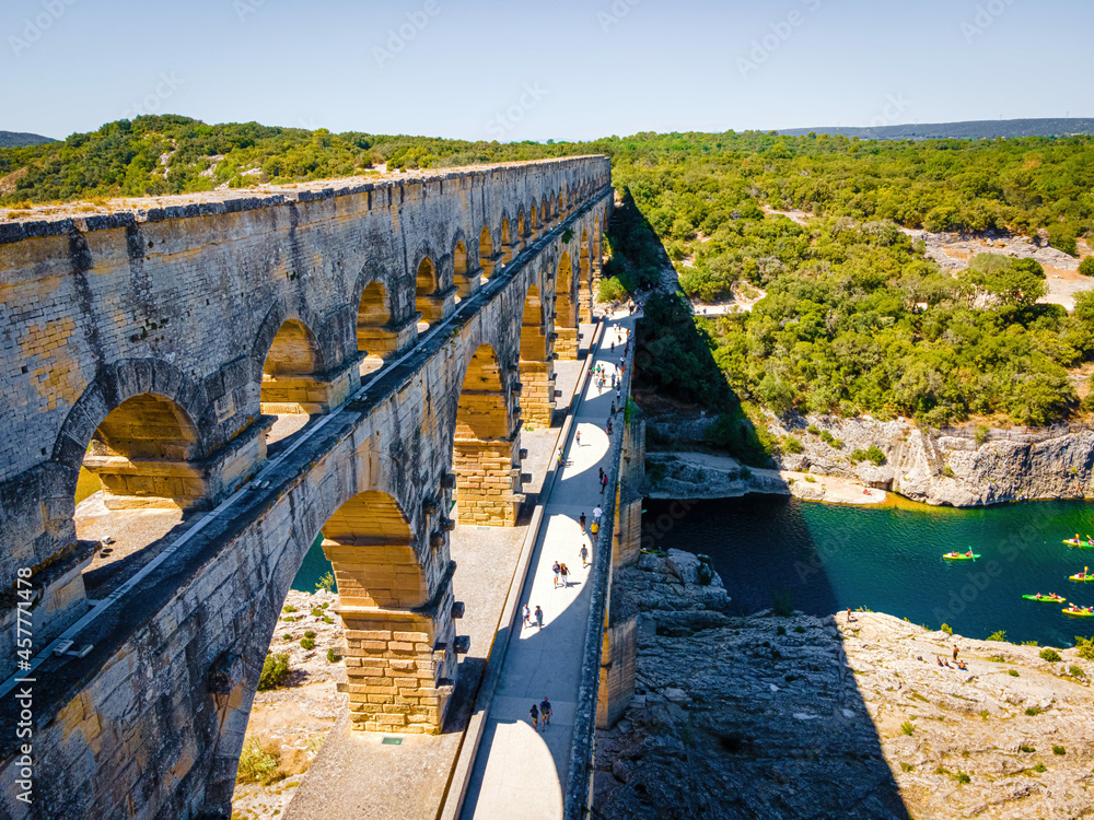 The aerial view of the Pont du Gard, an ancient tri-level Roman aqueduct bridge in France - obrazy, fototapety, plakaty 