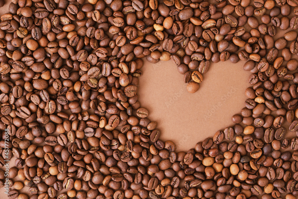 Heart made from coffee beans on brown background. Heart made from coffee beans on brown background.