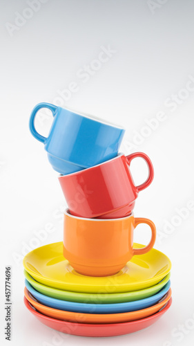 Colorful coffee cup on colorful paper background A lot of cups for coffee and tea in coffee shop Food and drink background concept