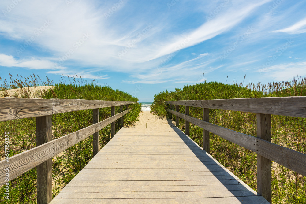 Wooden boardwalk over the dunes to the sea Wooden boardwalk over the dunes to the sea