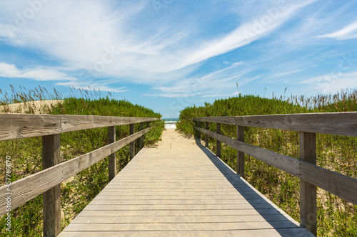 Fototapeta Naklejka Na Ścianę i Meble -  Wooden boardwalk over the dunes to the sea
