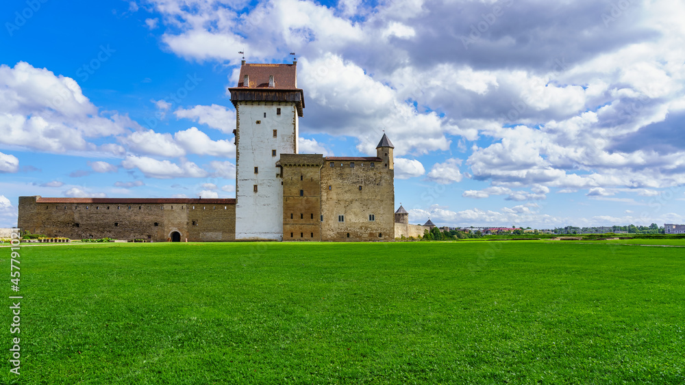 Panoramic of medieval castle in Narva Estonia with cloudy sky.