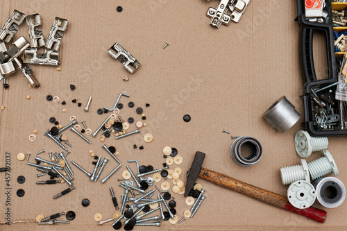 Screws and furniture fittings with a hammer against