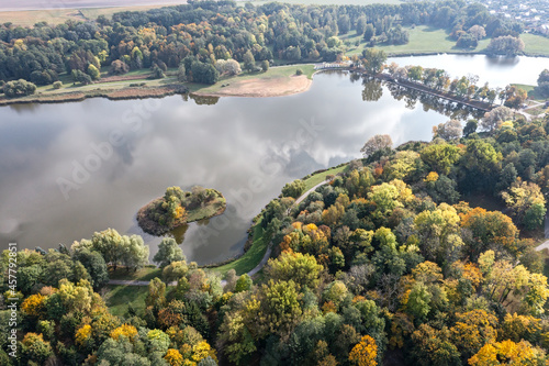 picturesque aerial view of lake and forest at early autumn. sunny autumn landscape.