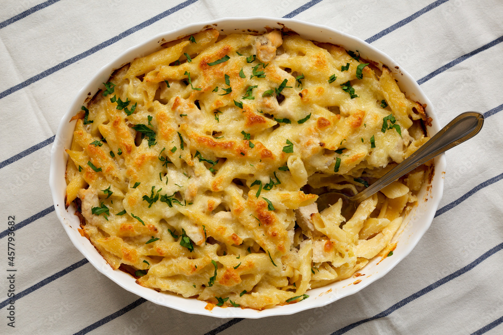 Homemade Chicken Alfredo Pasta Bake with Parsley, top view. Flat lay, overhead, from above. Homemade Chicken Alfredo Pasta Bake with Parsley, top view. Flat lay, overhead, from above.