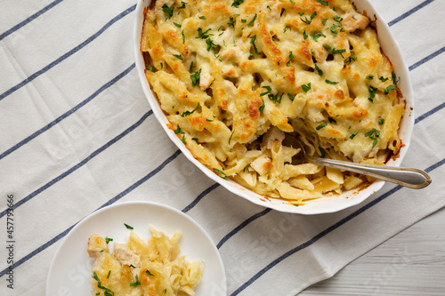 Homemade Chicken Alfredo Pasta Bake with Parsley, overhead view. Flat lay, top view, from above. Space for text.