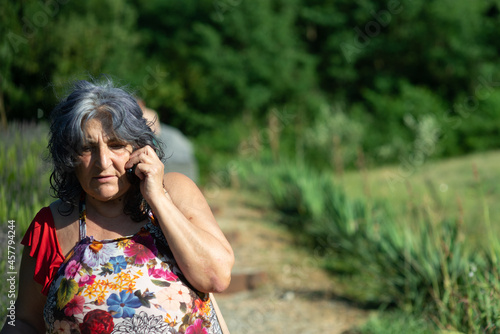 Lady at the phone in a park in summer photo