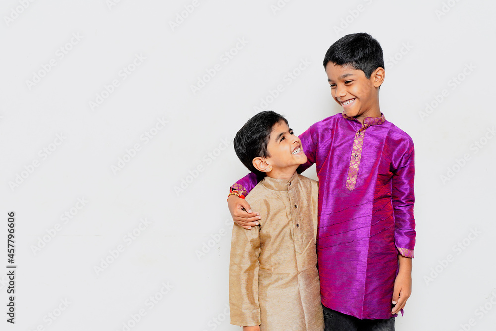 cute little Indian children's traditional wear standing isolated on a white background. Indian festival concept cute little Indian children's traditional wear standing isolated on a white background. Indian festival concept