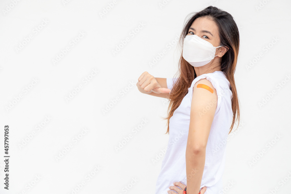 Asian Women Show Bandage On Arm. Happy Asian Woman Feels Good After Received Vaccine On White Background. Asian Women Show Bandage On Arm. Happy Asian Woman Feels Good After Received Vaccine On White Background.