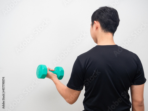 Man holding drumbbell for workout stand turn back