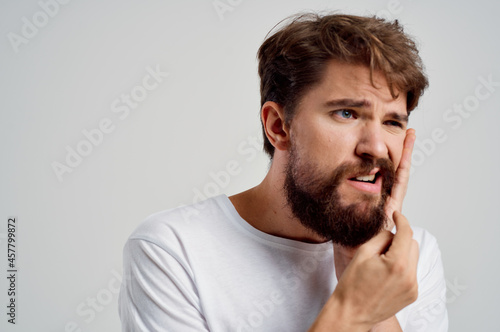 bearded man medicine toothache and health problems light background