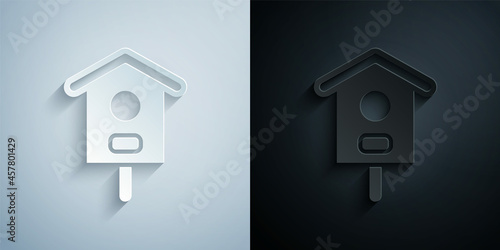 Paper cut Bird house icon isolated on grey and black background. Nesting box birdhouse, homemade building for birds. Paper art style. Vector
