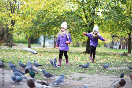 Leaf fall in the park. Children for a walk in the autumn park. Family. Fall. Happiness.