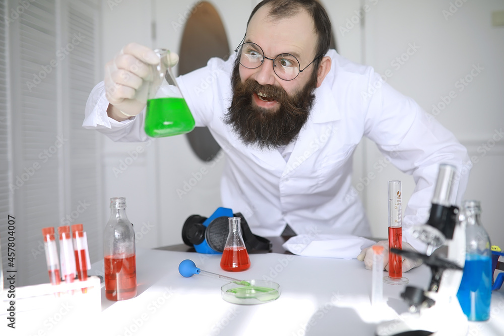 Chemist crazy. A mad scientist conducts experiments in a scientific laboratory. Performs research using a microscope. Chemist crazy. A mad scientist conducts experiments in a scientific laboratory. Performs research using a microscope.