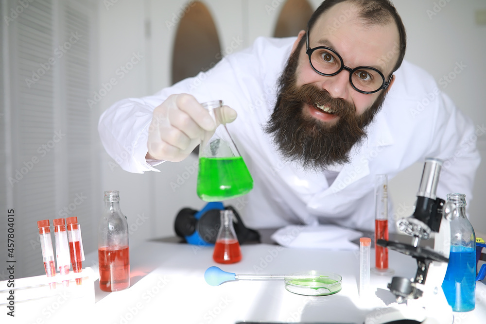 Chemist crazy. A mad scientist conducts experiments in a scientific laboratory. Performs research using a microscope. Chemist crazy. A mad scientist conducts experiments in a scientific laboratory. Performs research using a microscope.
