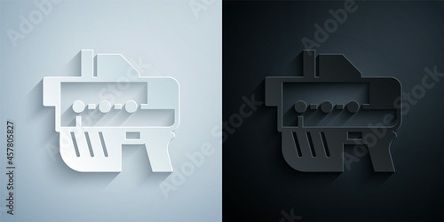 Paper cut Futuristic space gun blaster icon isolated on grey and black background. Laser Handgun. Alien Weapon. Paper art style. Vector