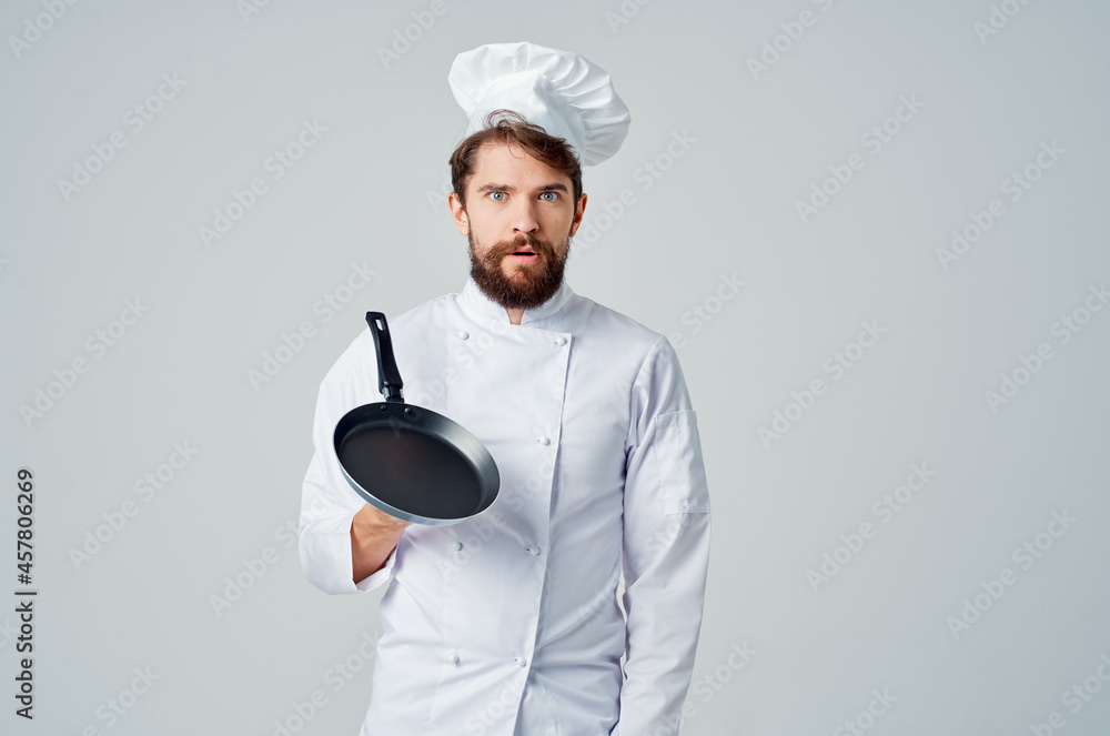 a man in a chef's uniform restaurant provision of services light background a man in a chef's uniform restaurant provision of services light background