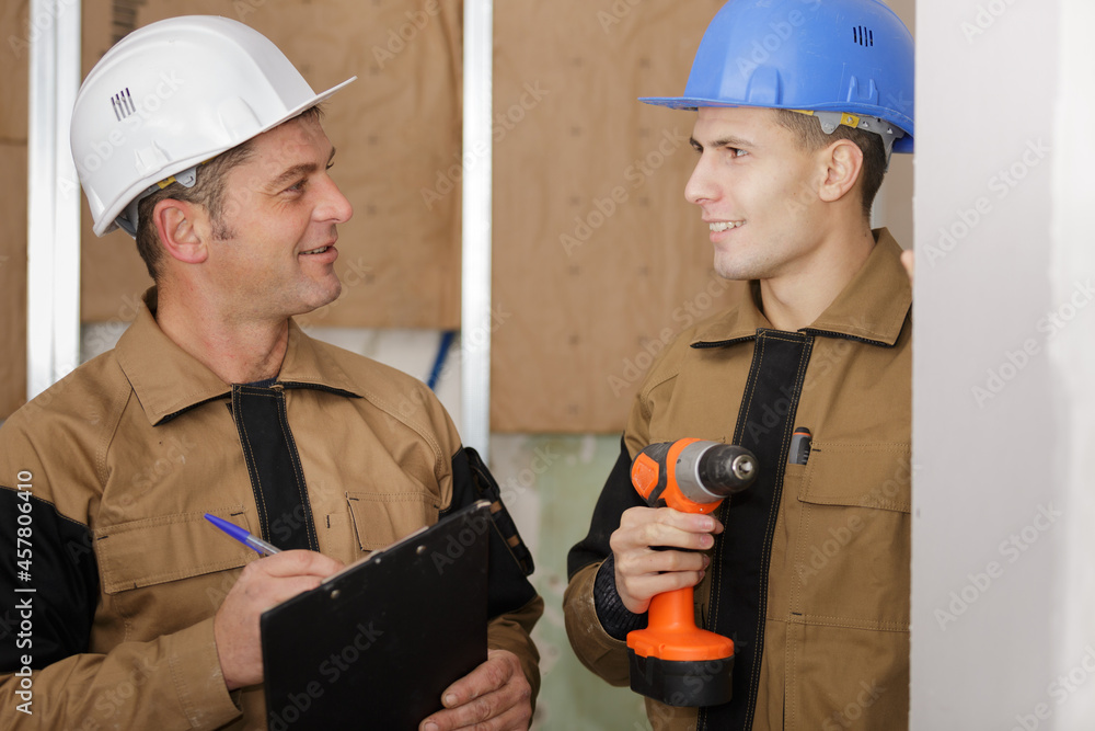 builders talking indoors builders talking indoors