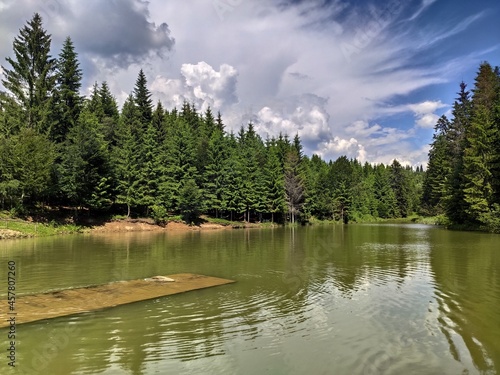 Fototapeta Naklejka Na Ścianę i Meble -  Lake near Tihuța Retreat, Romania Piatra Fântânele and a pontoon on the water, 2020