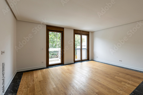 Interior of an empty apartment with wooden parquet