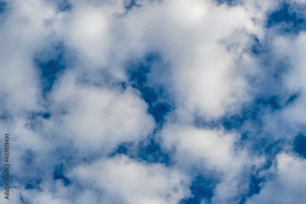 White fluffy cirrus clouds against the dark blue autumn sky. White fluffy cirrus clouds against the dark blue autumn sky.