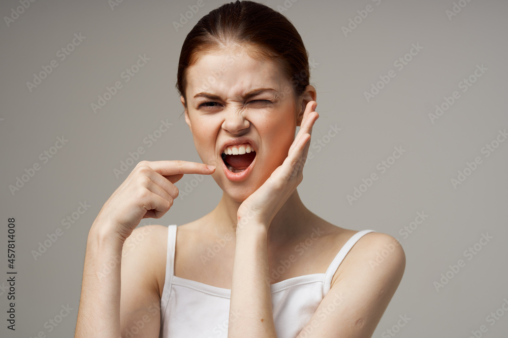 woman in white t-shirt toothache health problems disorder light background woman in white t-shirt toothache health problems disorder light background
