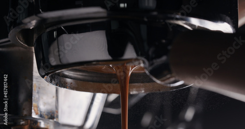 espresso pour from bottomless portafilter closeup
