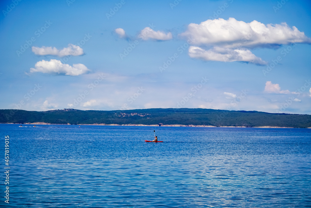 seascape, with relaxation on the water swimmer on a surfboard, the Adriatic Sea 