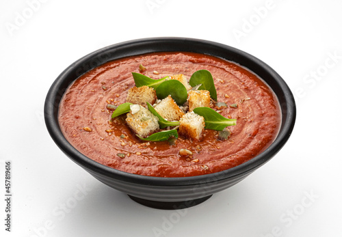 Bowl of tomato soup isolated on white background photo