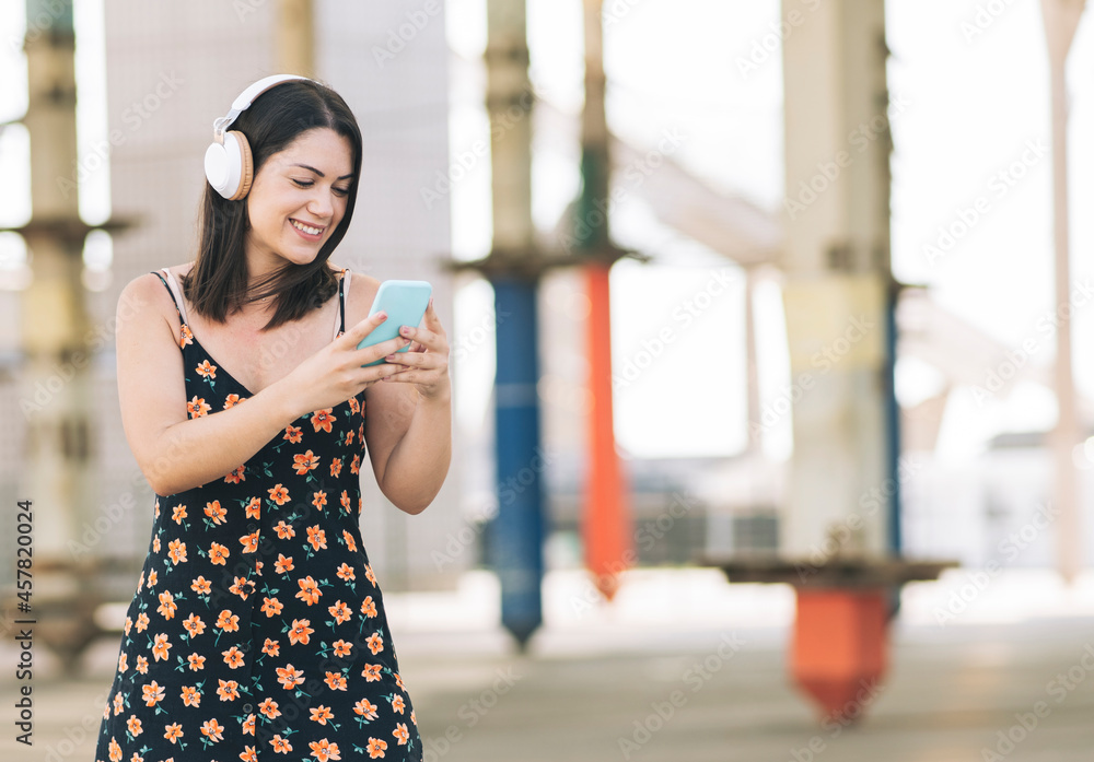 Fototapeta premium woman on skateboard while using smartphone