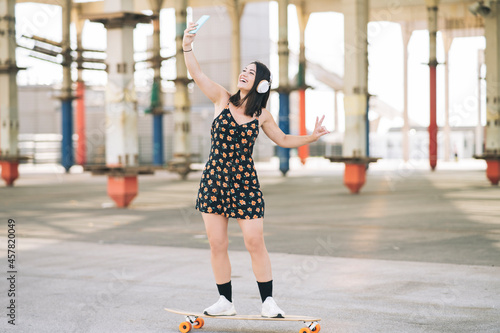 woman on skateboard taking selfie while skating