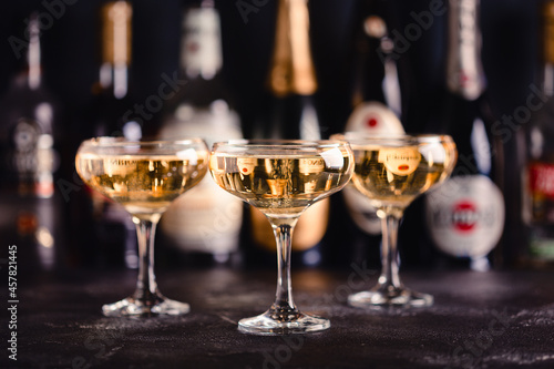 Champagne glasses on a dark background.