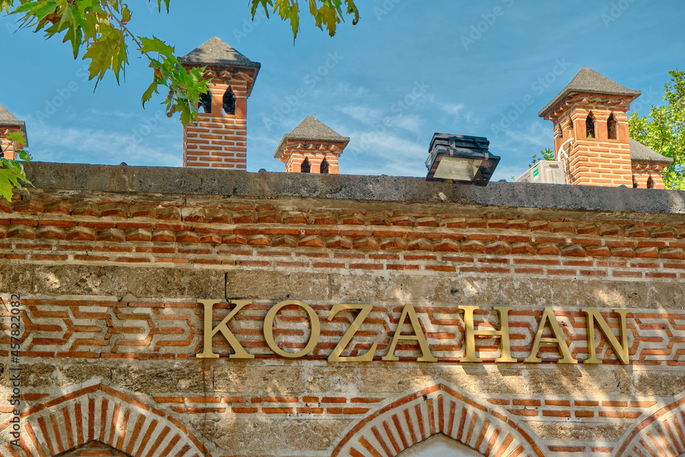 Wall of the ancient koza han (Translation of Kozahan: ancient traditional commercial house) and its wall and blue sky background in Bursa - obrazy, fototapety, plakaty 
